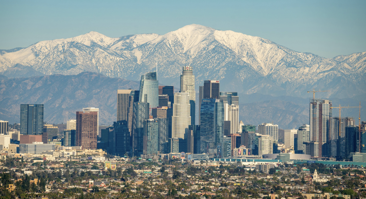Los Angeles downtown skyline with snow-capped mountains